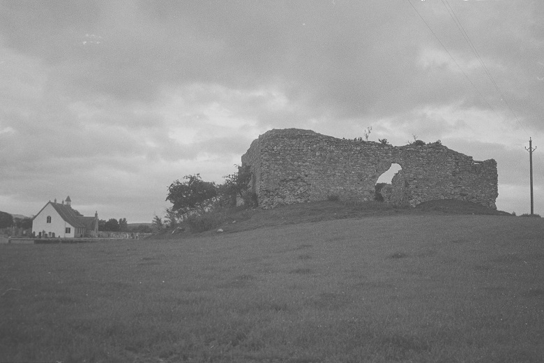 A black and white archive photo of the crumbling ruins of Castle Roy