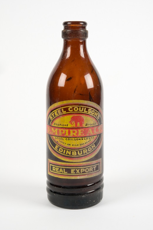 An empty brown glass bottle with a label reading "Empire Ale"