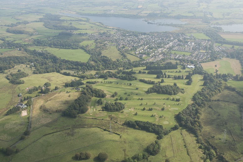 An aerial view of a village beside a loch
