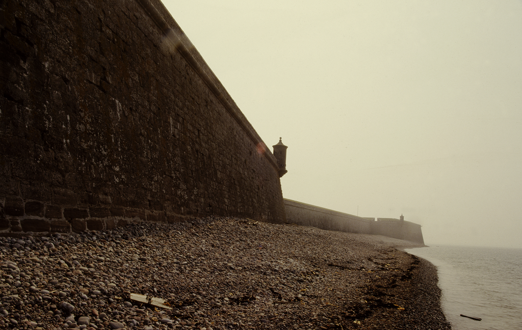 An atmospheric shot of the cloud and mist around the high walls of Fort George, with the sea on one side