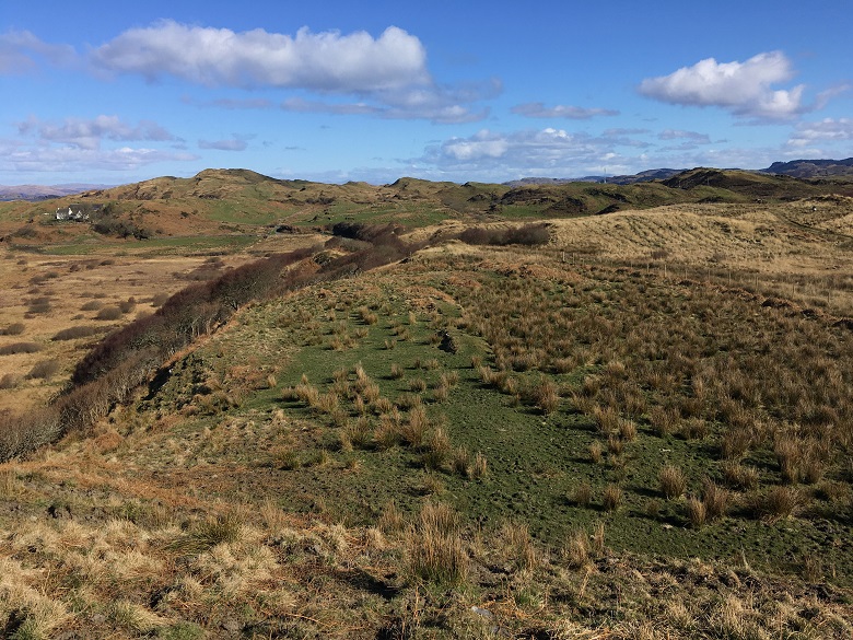 A general view of the site of a prehistoric roundhouse on hilly moorland 