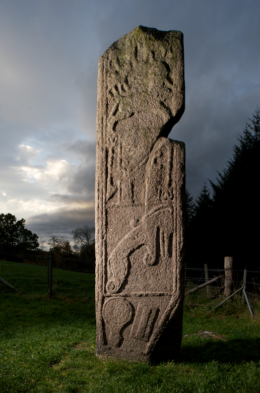 An intricately carved standing stone at twilight