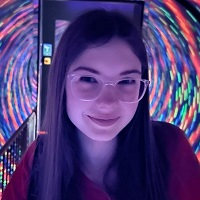 a young person with long dark hair and glasses inside a swirling tunnel of light