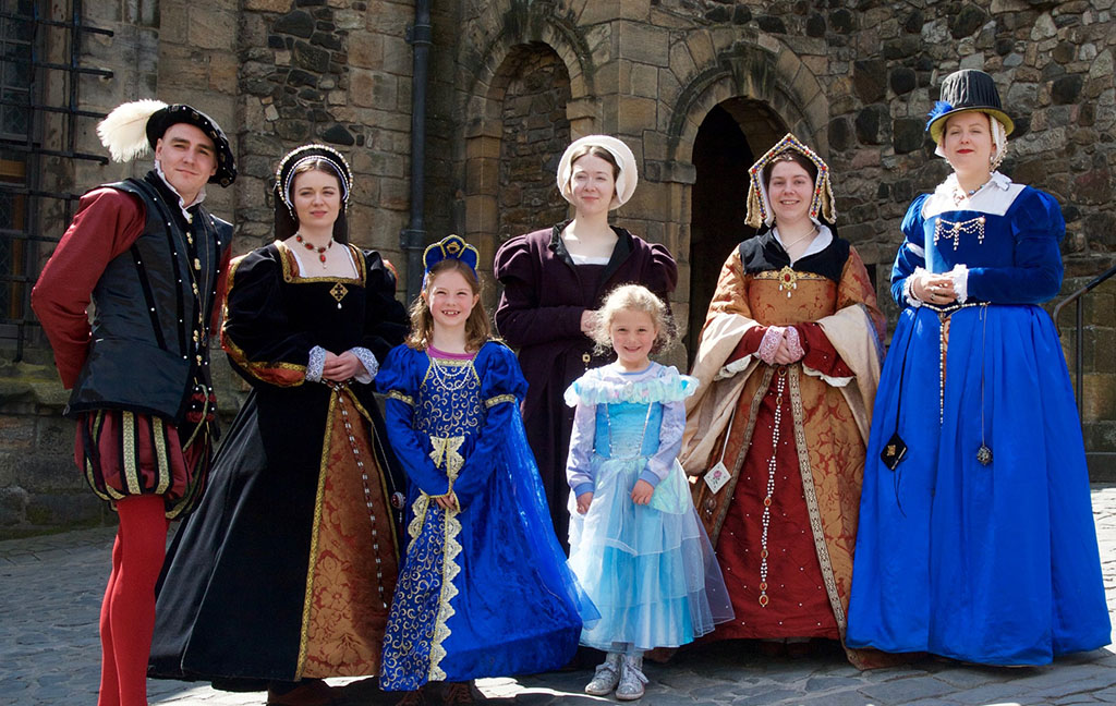 two little girls pose with costumed reenactors at Stirling Castle