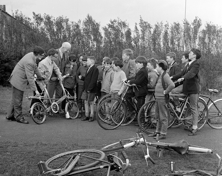 An archive photo of schoolboys and their bikes listening to the instructions of cycling instructors 