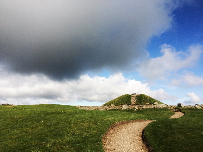 Grey clouds forming above a prehistoric hilltop monument 