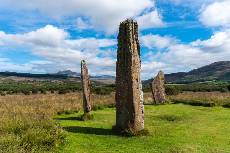 Three large standing stones in a isolated moorland setting 