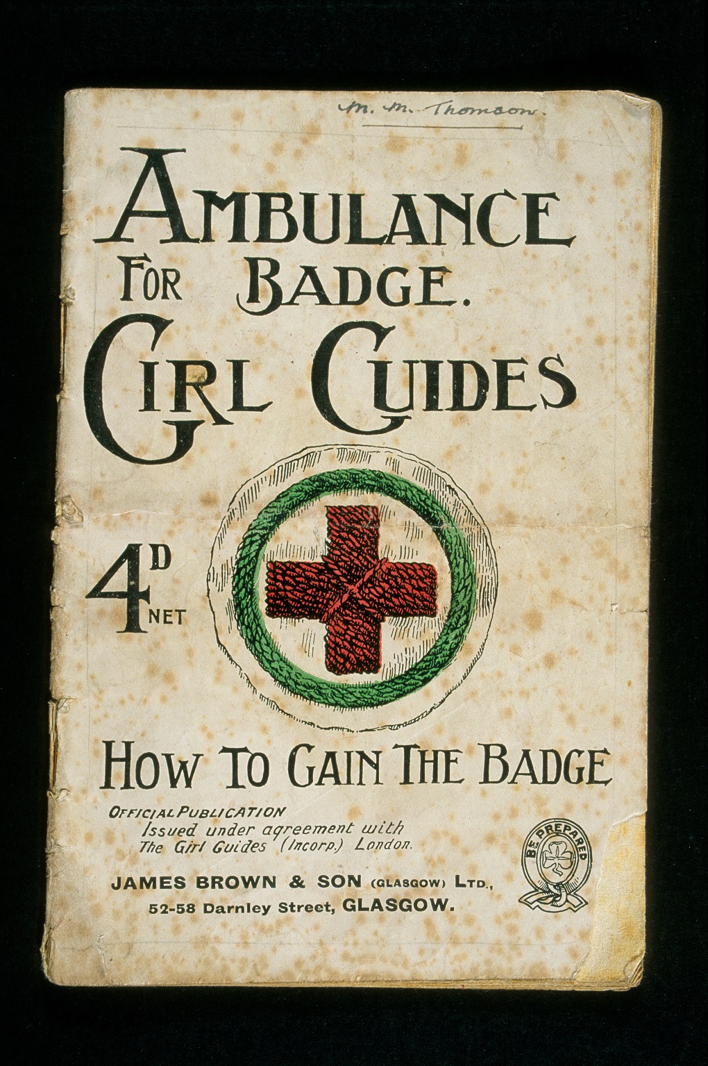 An archive photo of a Girlguiding booklet cover page on how girl guides can attain their ambulance badge. The text reads "Ambulance badge for Girl Guides. 4D NET. How to gain the badge"