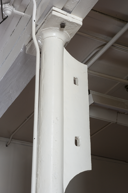 An iron column painted in a bright white