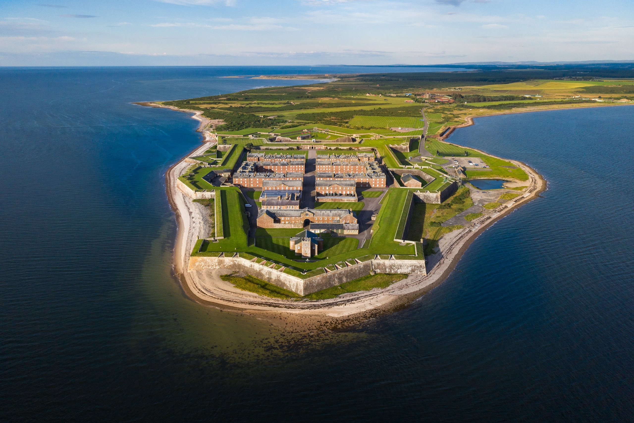Aerial view of Fort George surrounded by water. 