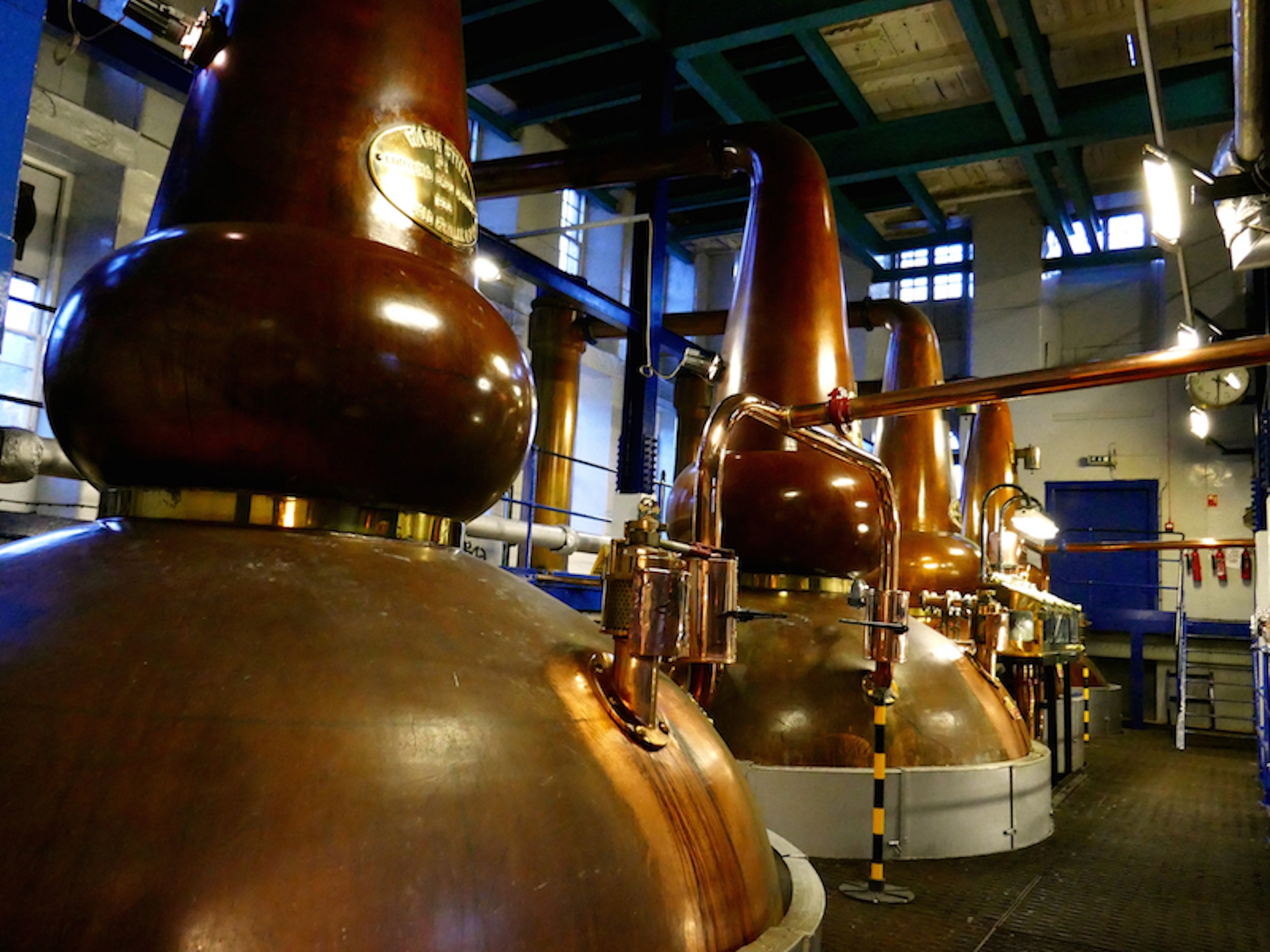 A close up of the copper tanks at a distillery