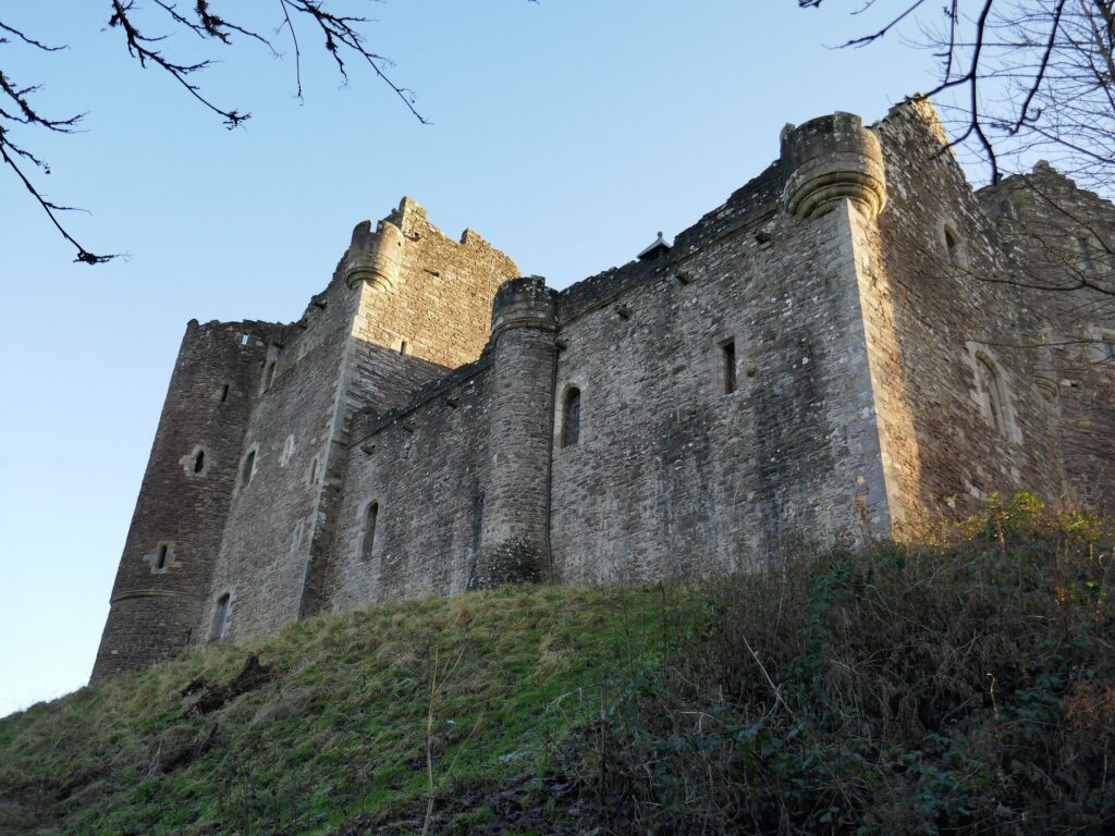 A stone castle on a hill. It's Doune Castle.