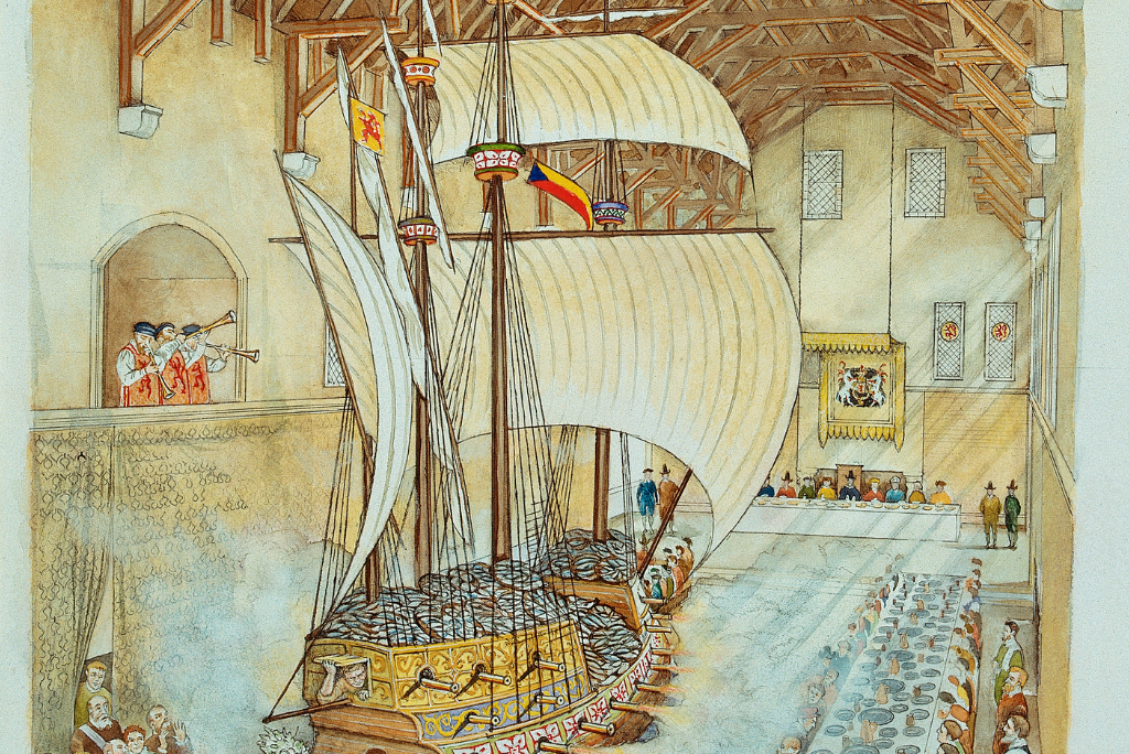 An illustration of the inside of the Great Hall. There is a large ship with a feat in the centre, trumpeters are sitting in the balcony high up.