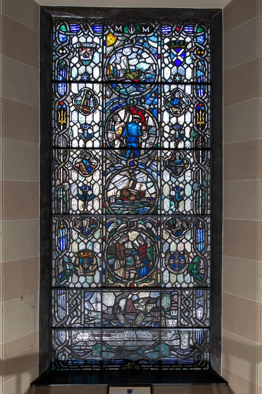 A colourful stained glass window commemorating the contribution made by mariners during the First World War. The scenes depict the different duties on board ship along with the flags and emblems of the Merchant Navy, Trinity House and Leith.