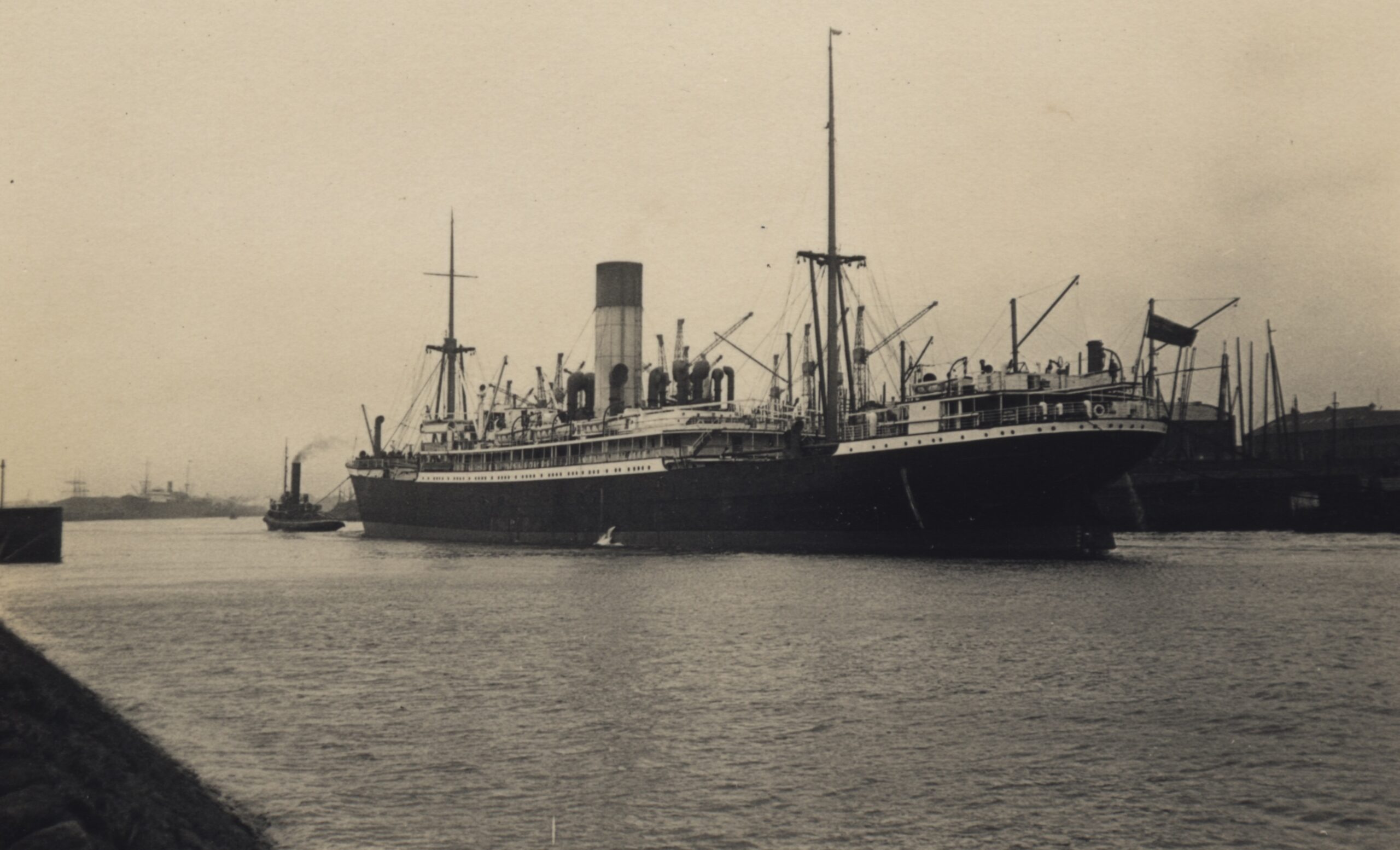 A balck and white archive photo showing a large ship at sea