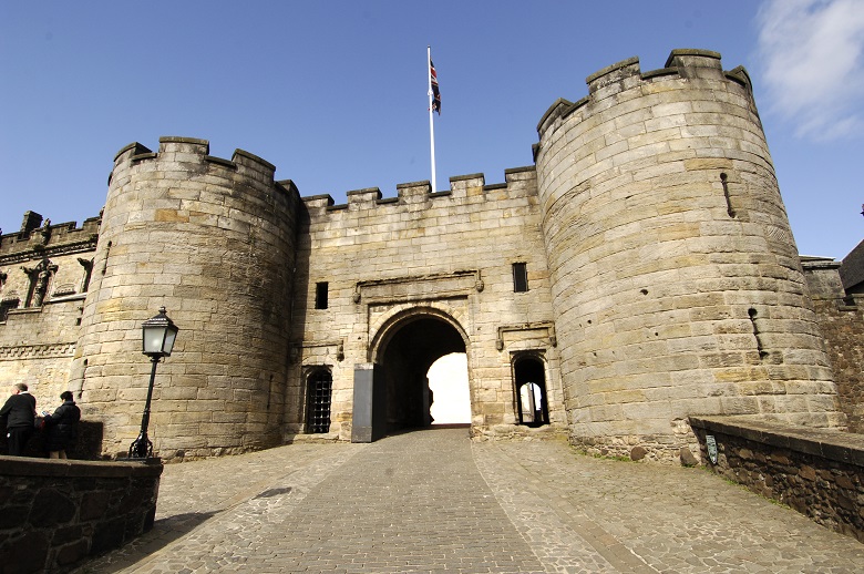 A large stone gate giving access to a castle
