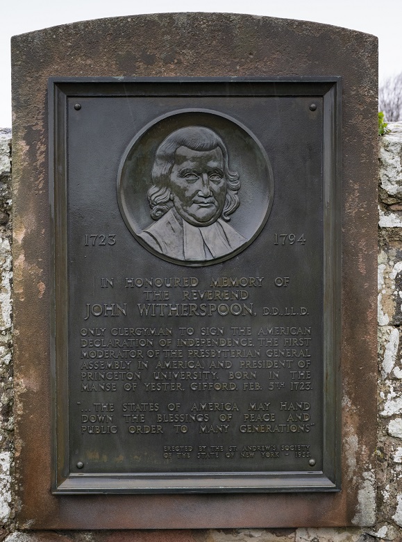 A close-up of a metal plaque commemorating John Witherspoon featuring the year of his birth and death and details of his achievements.