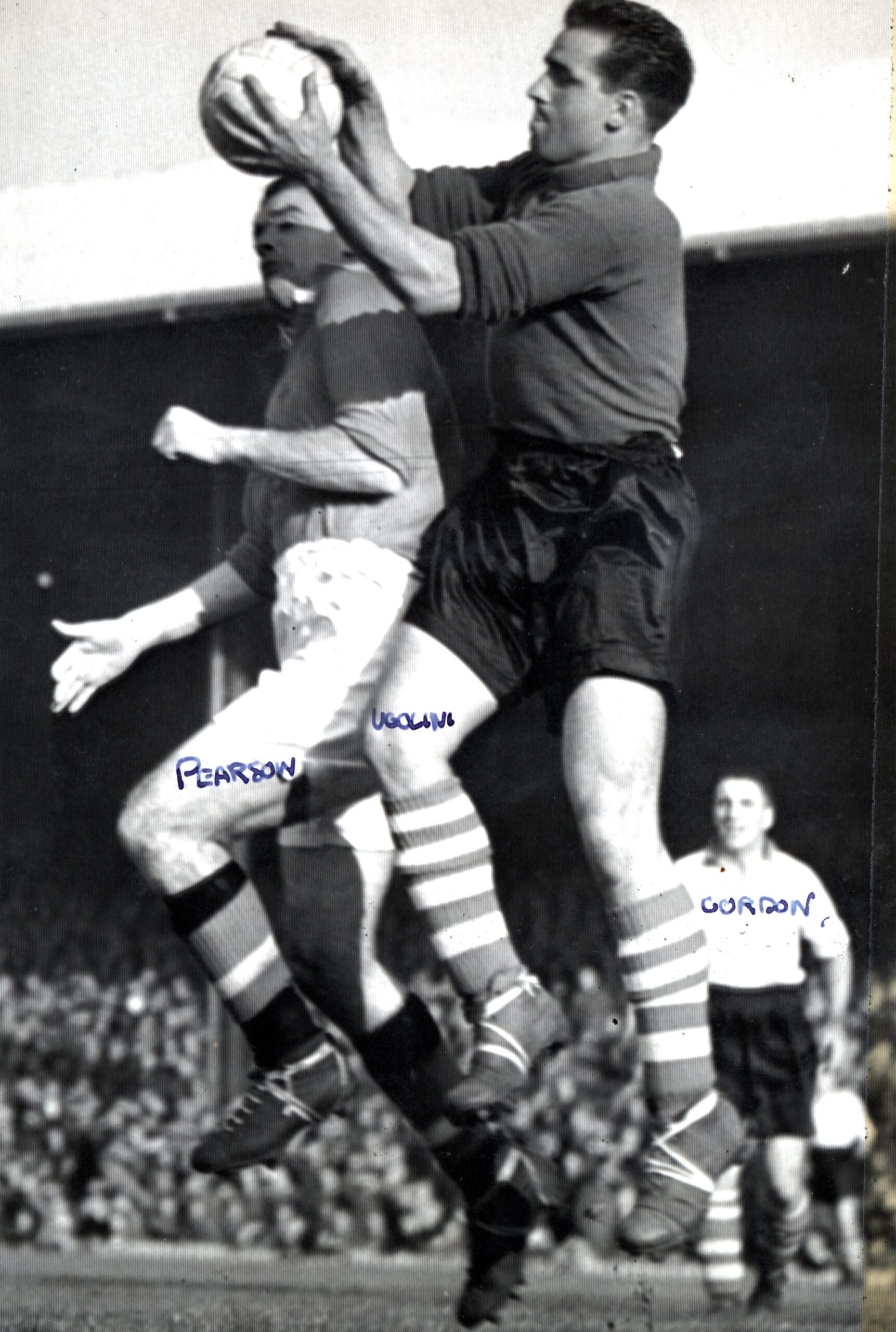 Black and white archive photo of Italian Scot Ugolini catching the ball mid air from a player from the other team. 