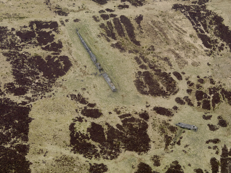 An aerial photo showing a large concrete wall in the middle of a remote and isolated moor