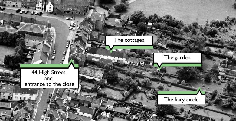 aerial photograph showing the Greengate Close area.The front of the commune is a terraced house on the high street, but through a close a number of small cottages stretch out behind the frontage on the high street. A long garden runs alongside the cottages and continues even further past the cottages.
