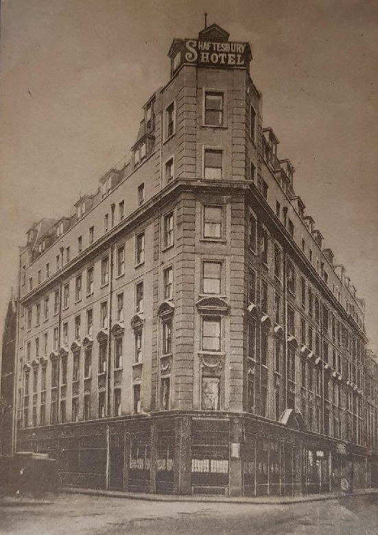 A London hotel with several stories. The main entrance is on the corner where two streets meet, making the building appear wedge-shaped. 