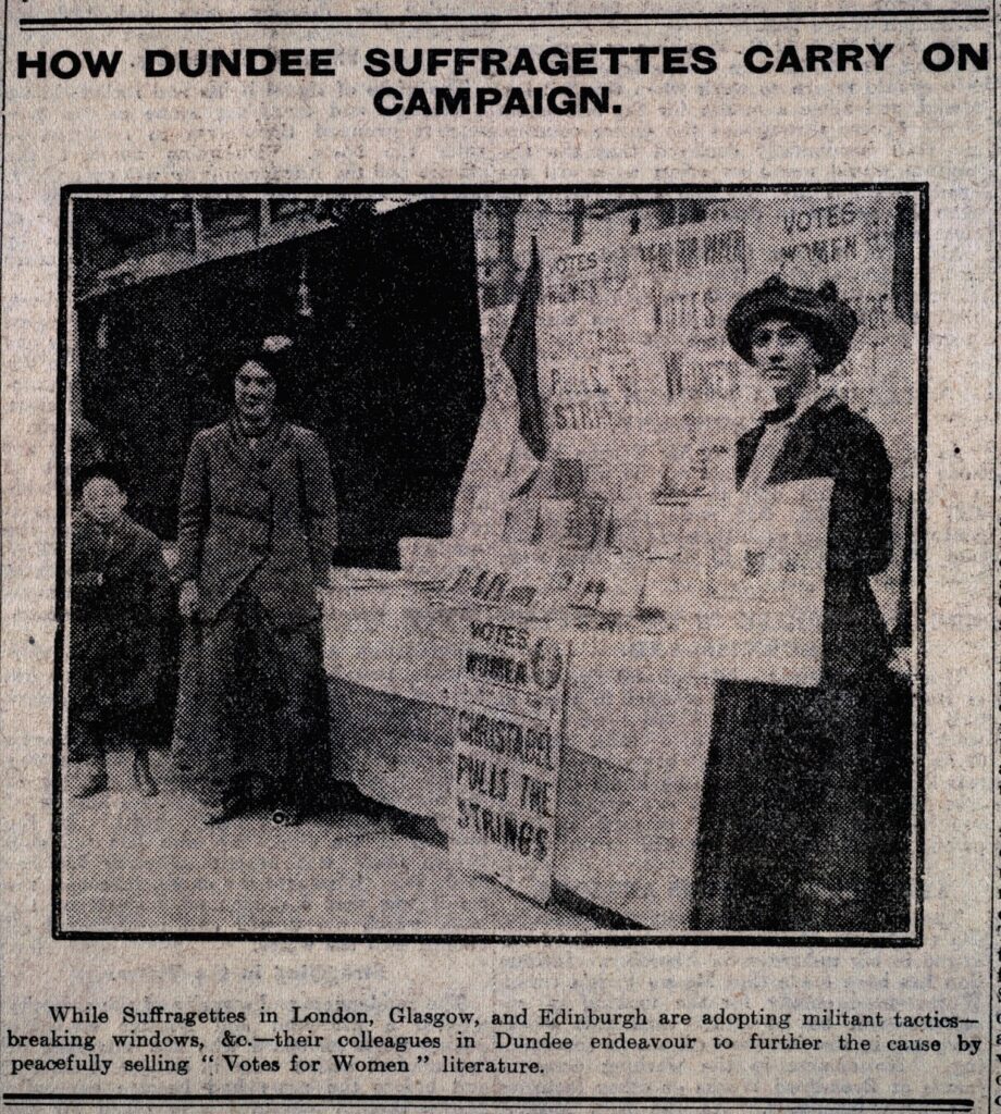 In this 1912 photograph Dundee suffragettes are shown "peacefully" promoting their cause. The caption accompanying the photograph favourably compares them with their more militant colleagues in other cities.