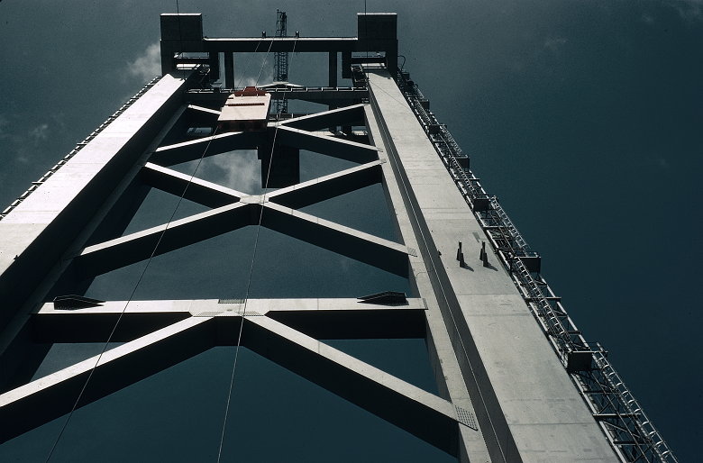 A photo taken with the camera looking up at one of the Forth Road Bridge's huge towers. Some material is being hoisted to the top.