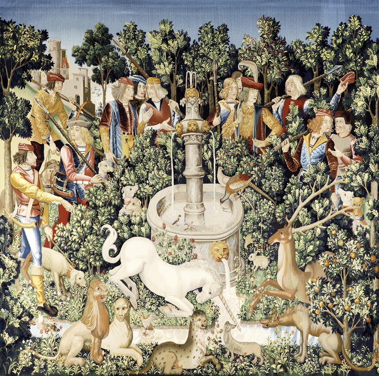 Large complex and colourful tapestry showing a medieval hunting party chasing down a unicorn. THe unicorn has collapsed in front of a fountain in a garden and the hunters and their dogs surround it.