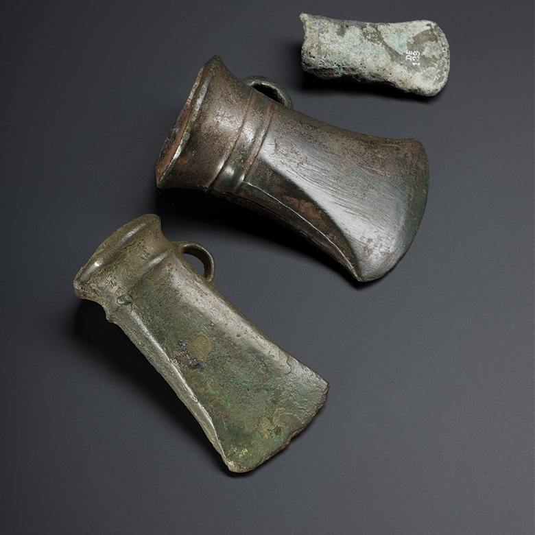 Three bronze axe heads which were discovered in Holyrood Park