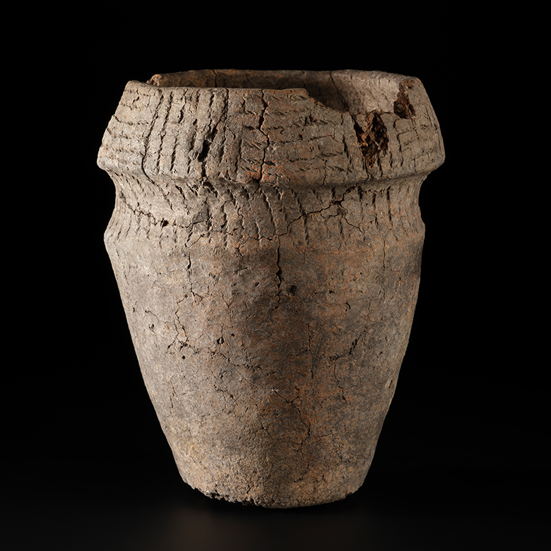 An ancient urn, which has become cracked over time but is still remarkably complete. 