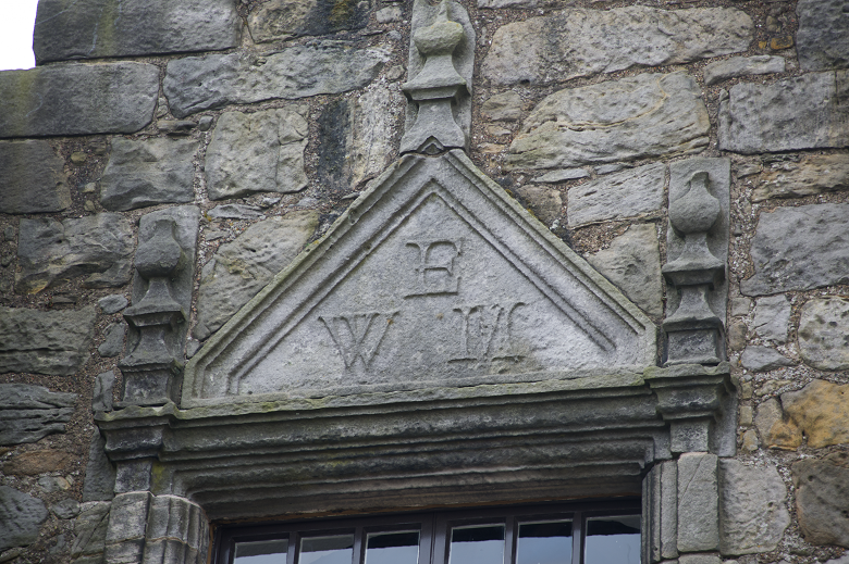 The initials WEM for William, 8th Earl of Morton, carved above a window at Aberdour Castle.