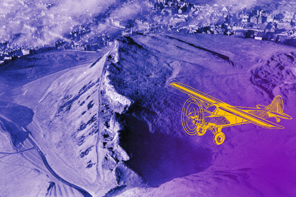 An aerial photo of Holyrood Park. It's tinted purple with an illustration of a plane in yellow flying over. The crags are at the centre of the image and behind them is the city of Edinburgh. The city is under a blanket of smog but here and there church spires and landmarks emerge from the smoke.