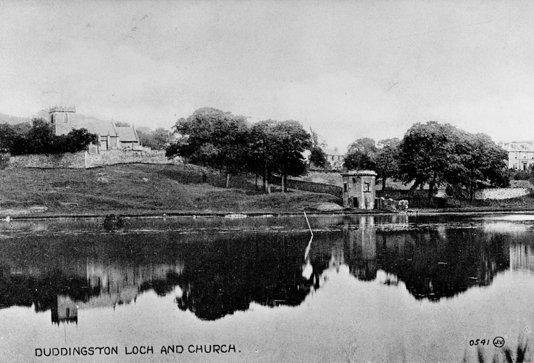 A view of Duddingston Loch in the summer. On the far shore is a small hexagonal tower and Duddingston Church on top of a hill.