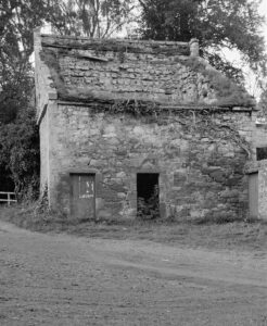 Black and white archive photo of a doocot with a small door