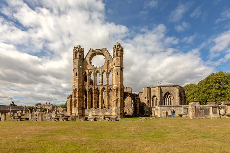 A towering stone cathedral ruin, where a lot of the detailed stonework can still be seen