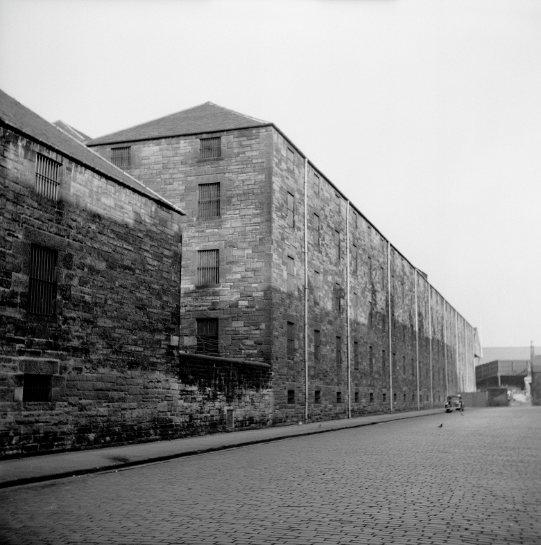 Industrial building in an open street, in black and white.
