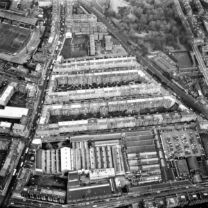Aerial view of tenement houses and factories in black and white.