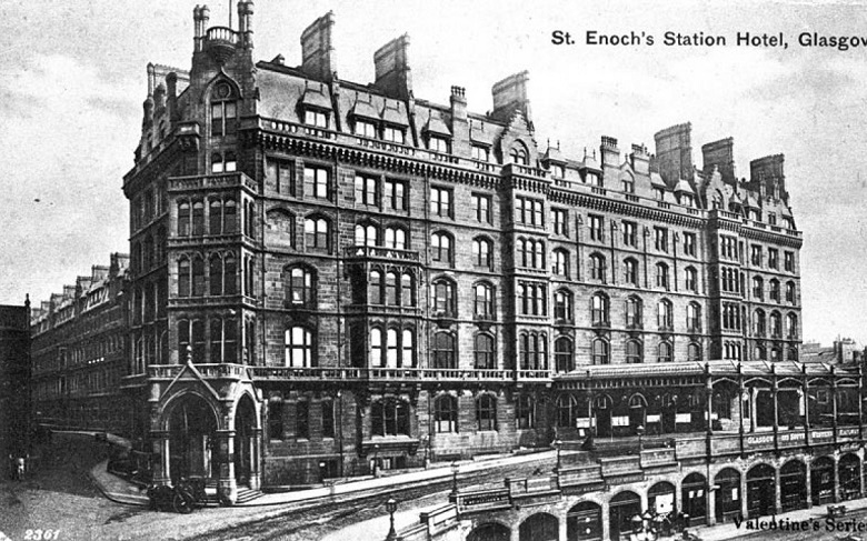 Black and white photograph of St. Enoch's Station Hotel in Glasgow. The multi-storey building features ornate architecture, numerous windows, and several chimneys. An arched entrance is visible at the front, with a street running alongside. A sign reading “Glasgow & South Western Railway” appears near the bottom right. The image is labeled “St. Enoch's Station Hotel, Glasgow” in the top right corner and “Valentine's Series” in the bottom right.