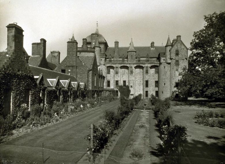 A long well-kept garden, at the end is a modest castle.