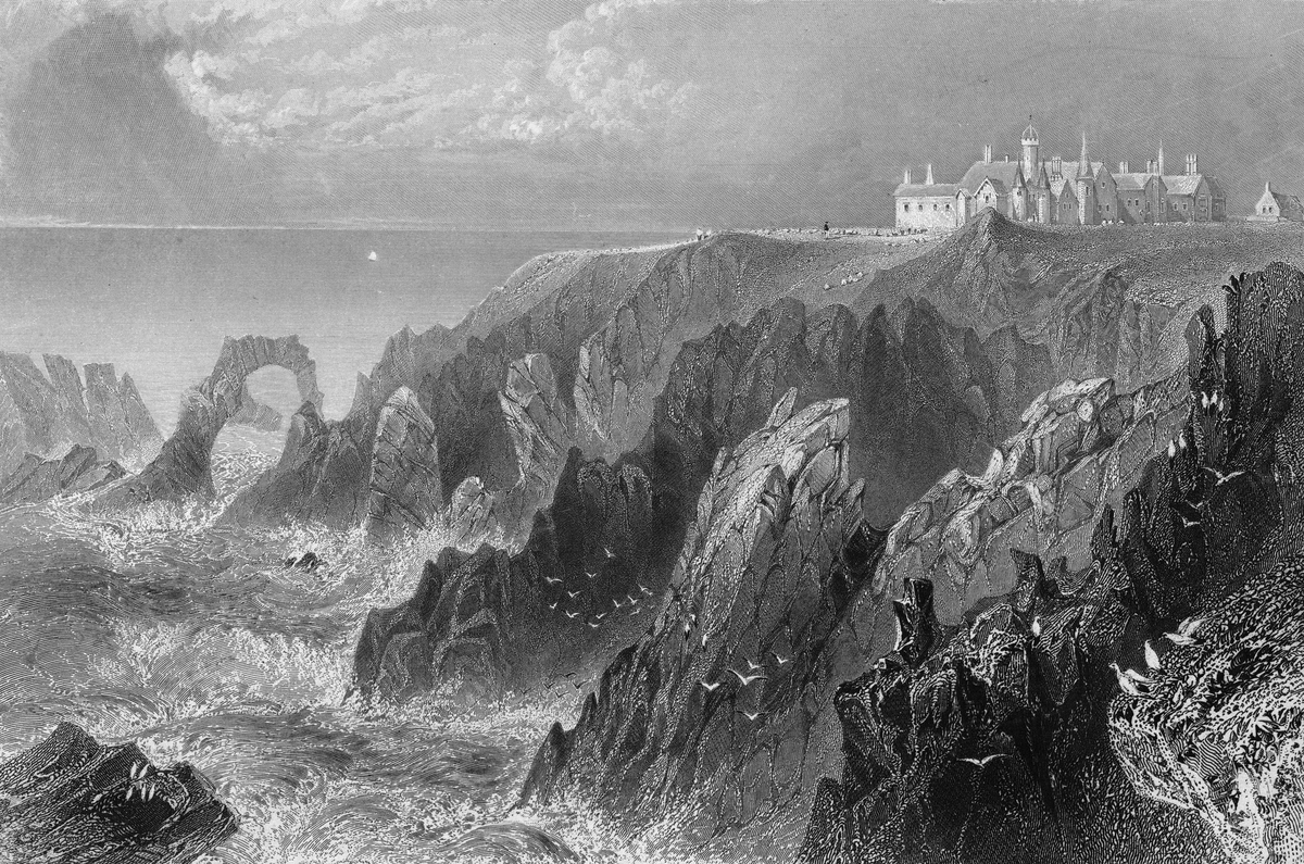 Black and white archive photo showing a castle on cliffs with the raging sea and seagulls in the front.