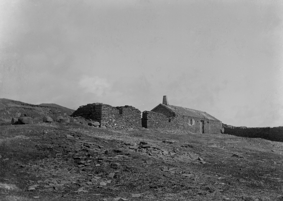 black and white archive image of a ruined cottage