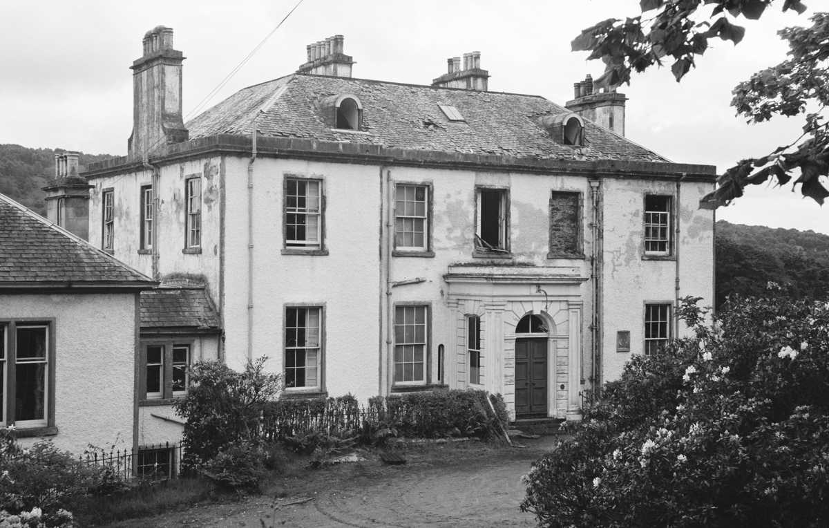black and white archive photo of a large house with rectagonal windows.
