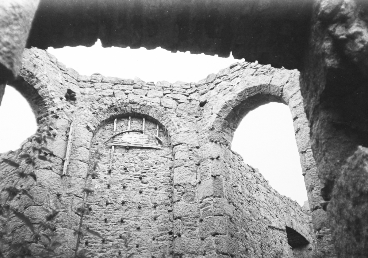 black and white archive photo of a castle wall with round windows