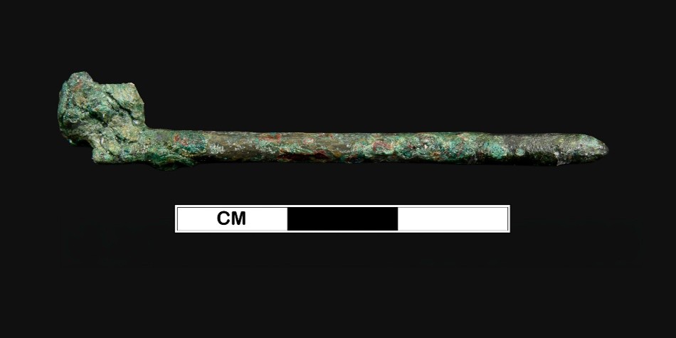 Excavated hand pin against a black background.